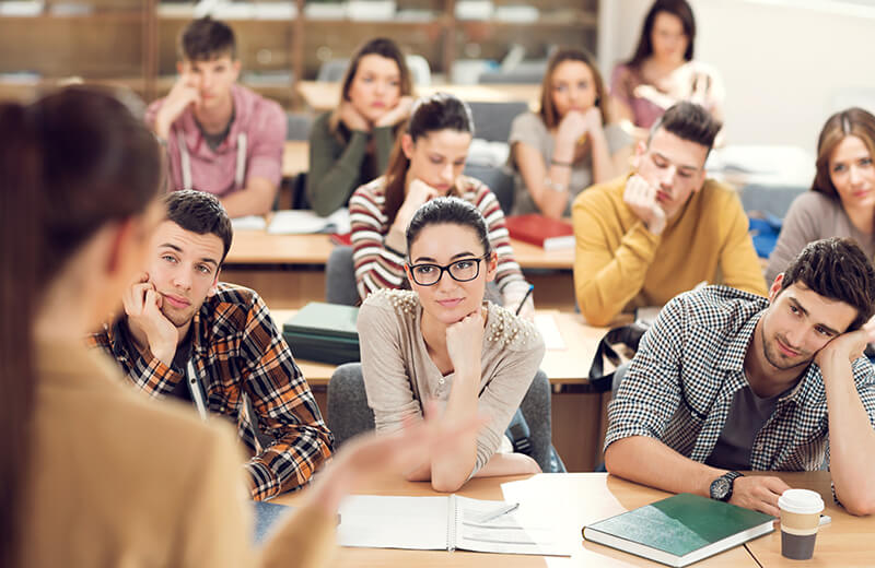 Students listening to lecture in class and trying to stay focused.