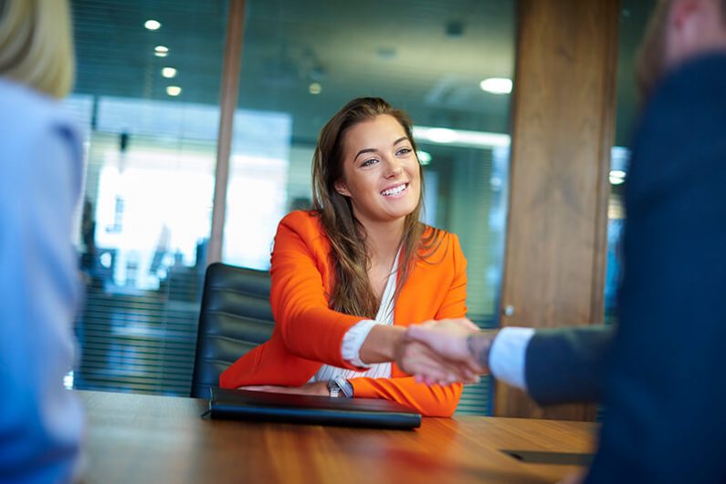 Woman shaking hands with her interviewer