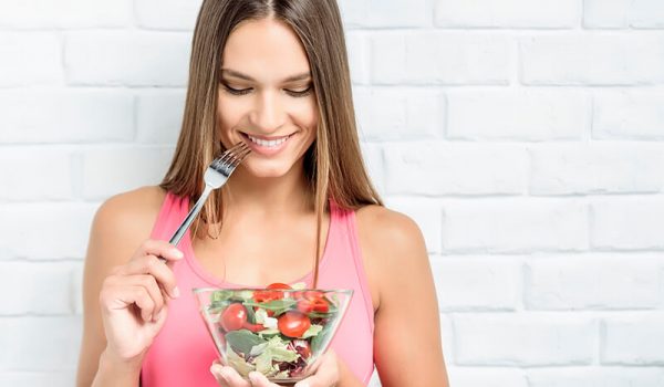 Young woman eating a salad