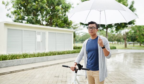 Male student on a rainy day outside