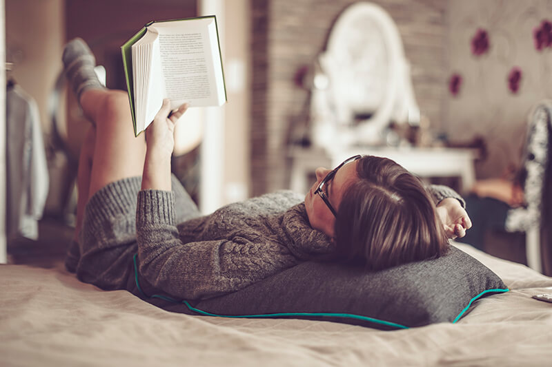 Student reading to help her academic writing