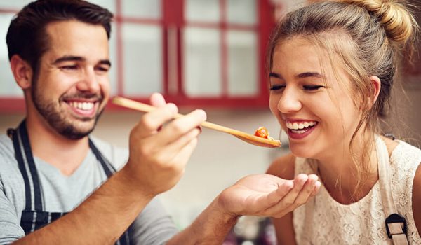 College students having fun cooking dinner