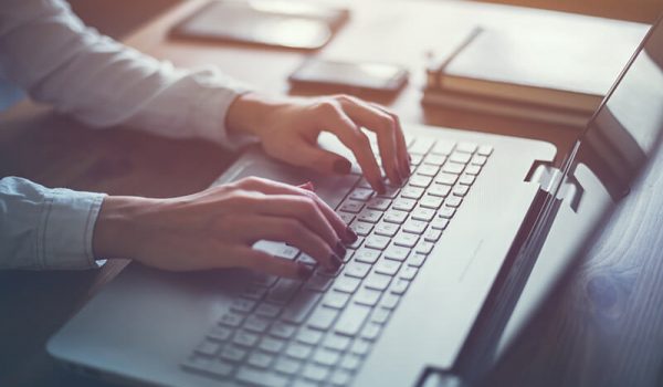 Essay writer typing out a paper