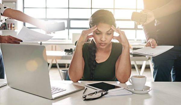 Female worker feeling overwhelmed in the office