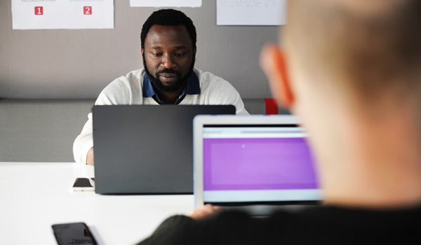 African man working on laptop while engaging in critical thinking skills