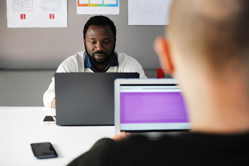 African man working on laptop while engaging in critical thinking skills