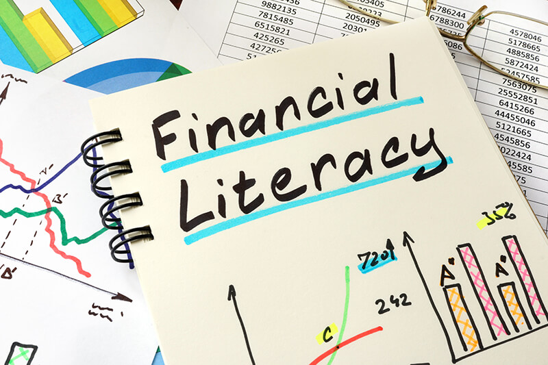 Image with title financial literacy and bar graph and line graph drawings