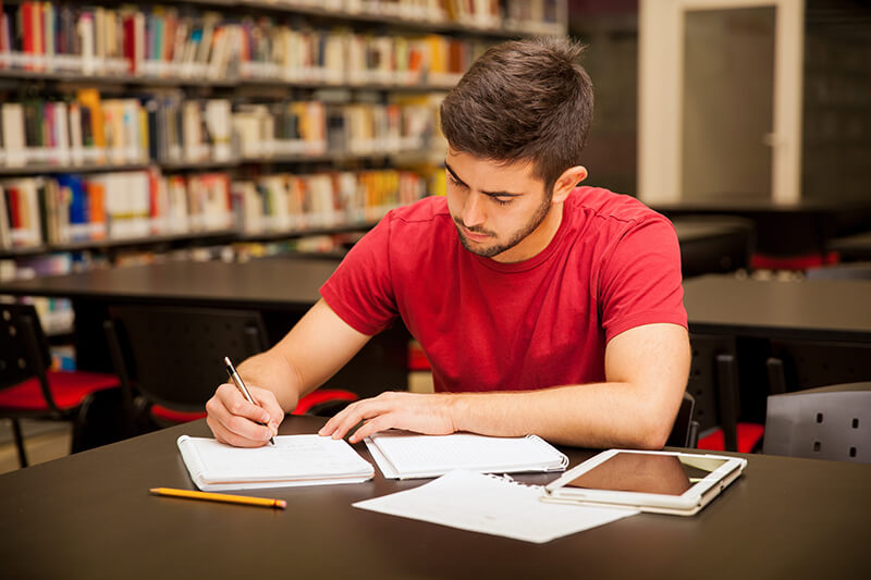 Student in the library developing good study habits