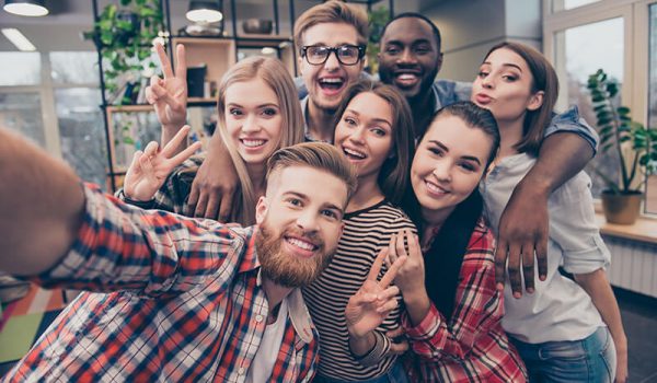 A group of friends at university taking a selfie