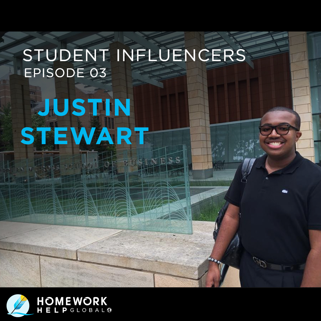 Justin Stewart standing in black shirt and pants in front of University of Michigan