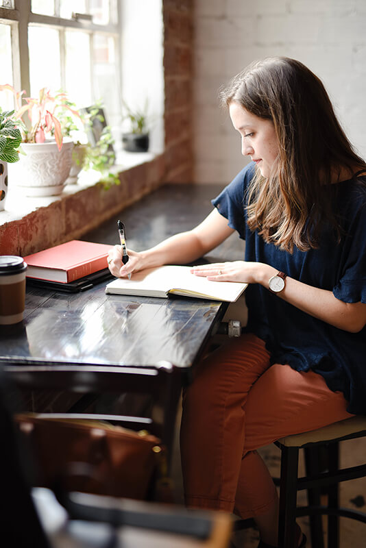 Female student writing a purpose statement