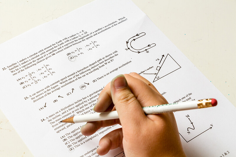 Female student writing a math exam