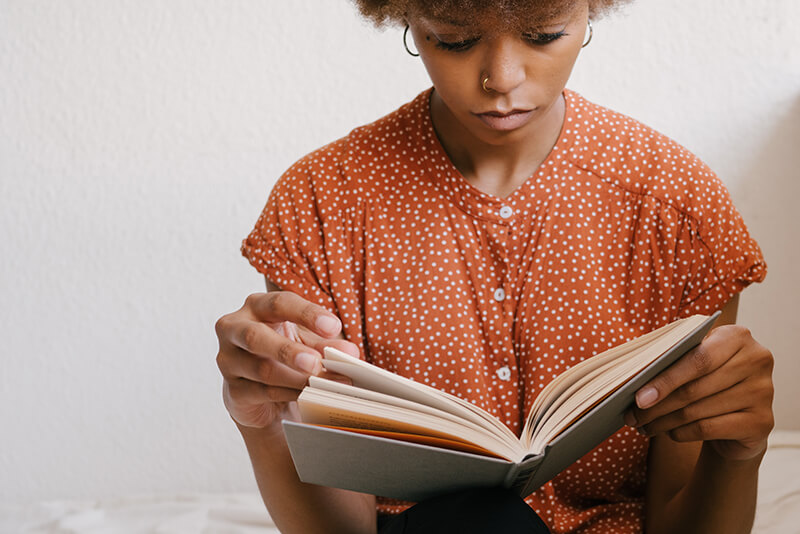 Female student reading from a book