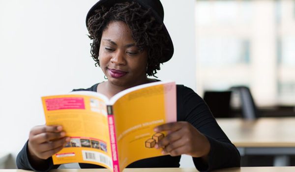 Female student learning how to write a good book report