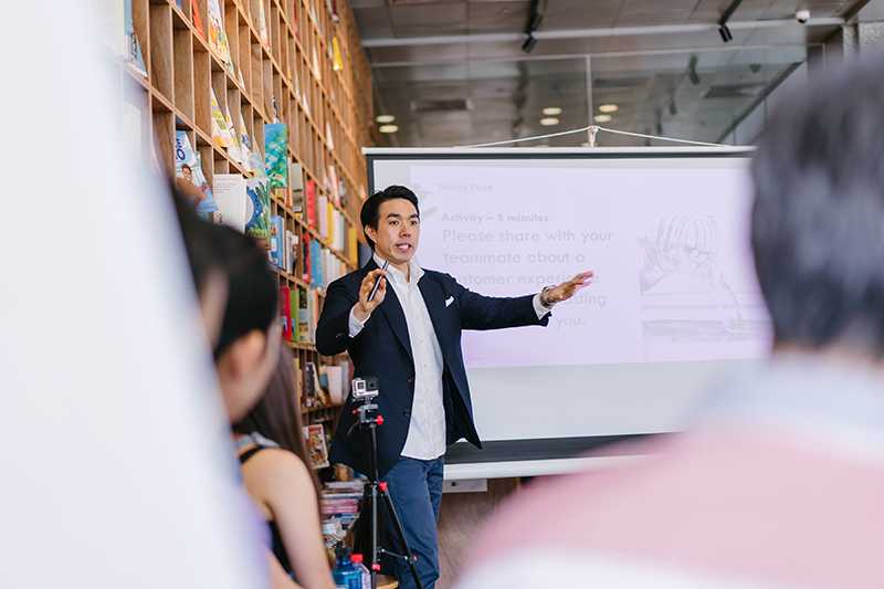 Male student presenting a speech to a group of students