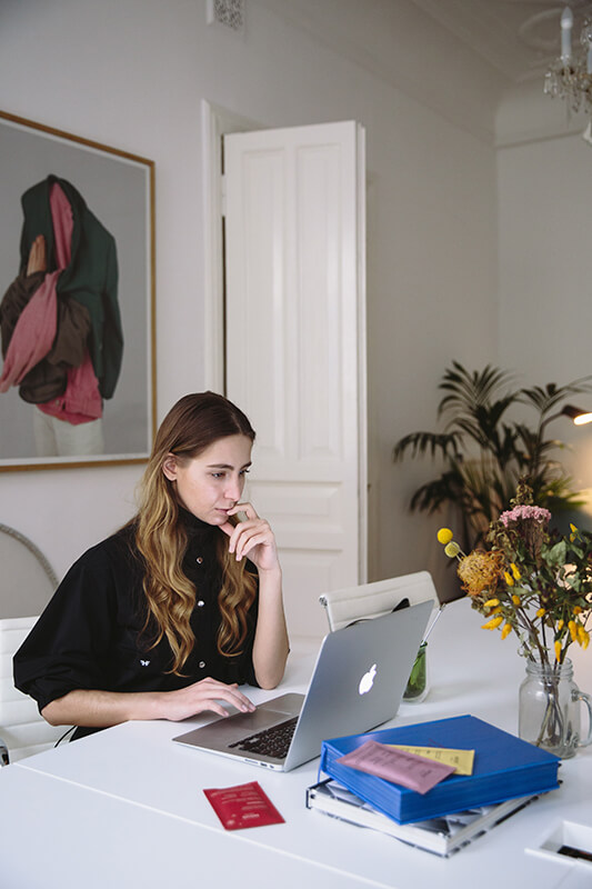 College student sitting at a laptop doing classwork