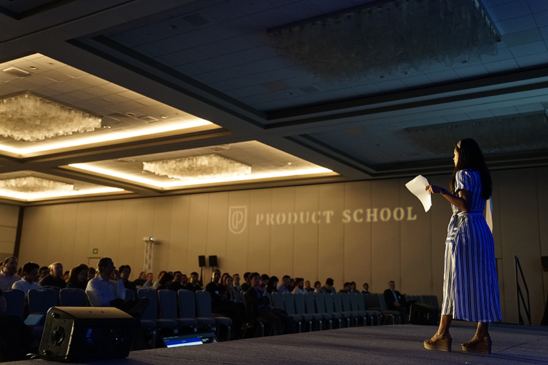 Woman leading an informative speech in front of a crowd