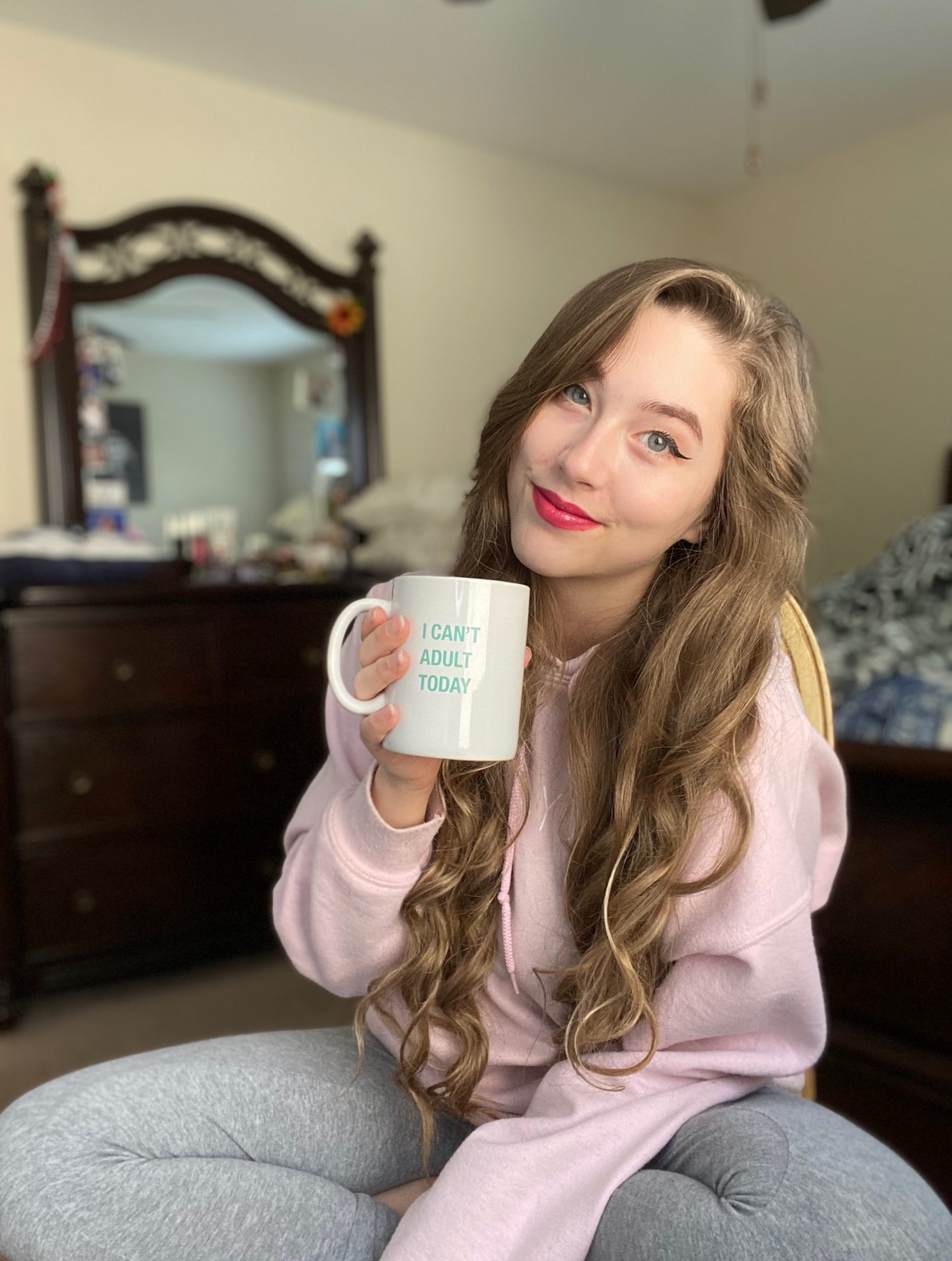Alexis with a coffee mug focusing on adjusting to university life and work balance