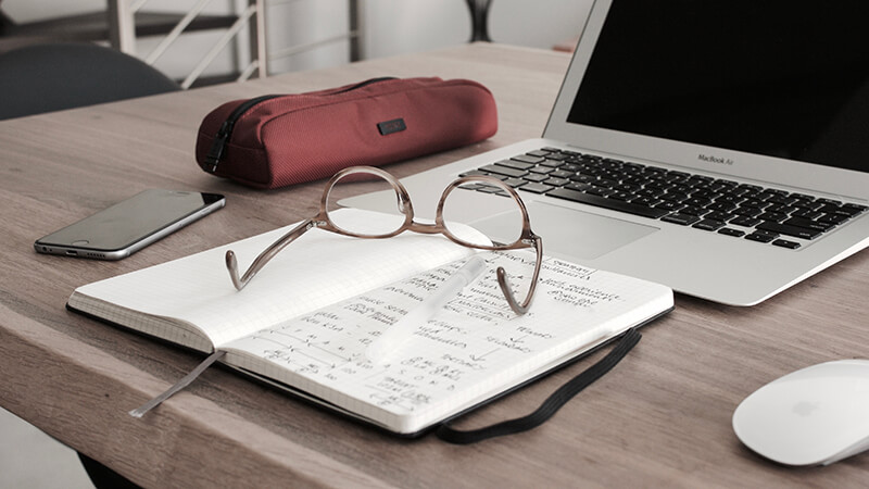 Student essay writing preparation materials on a desk