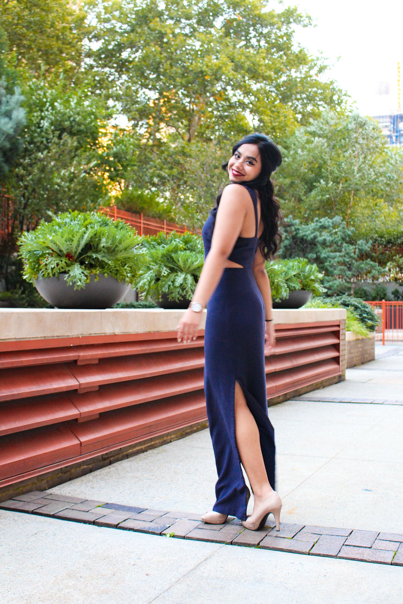 NYU student Qanetha Ahmed standing outside in a blue dress at her medical school formal