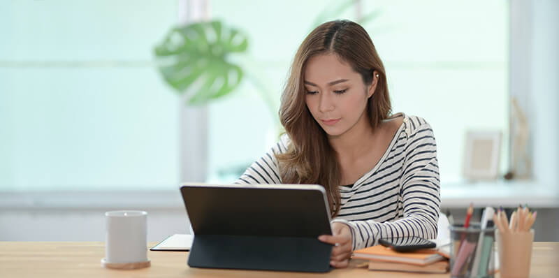 Female student writing down transition words on a tablet