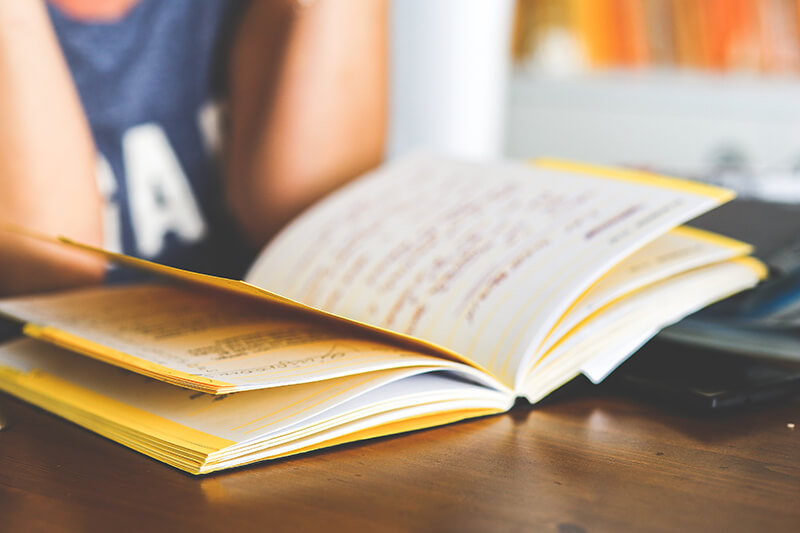 Close up of student flipping through information in a notebook