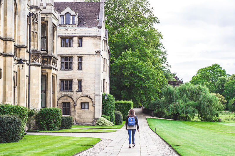 Student walking at the University of Cambridge in England, UK