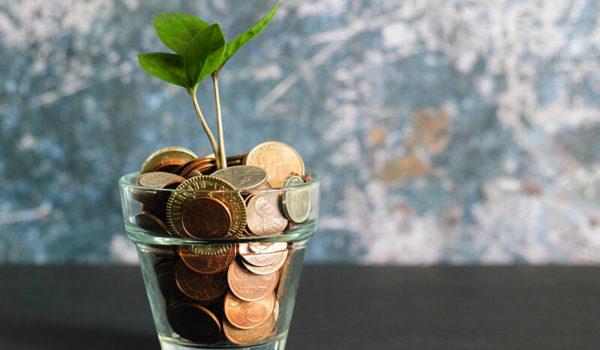 Plant pot full of coins on how to save money in college