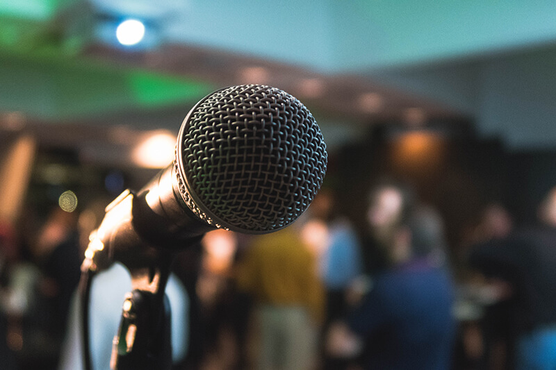 Microphone waiting for a speaker in front of an audience