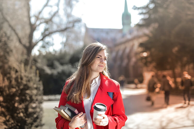 College student on campus budgeting for store bought coffee