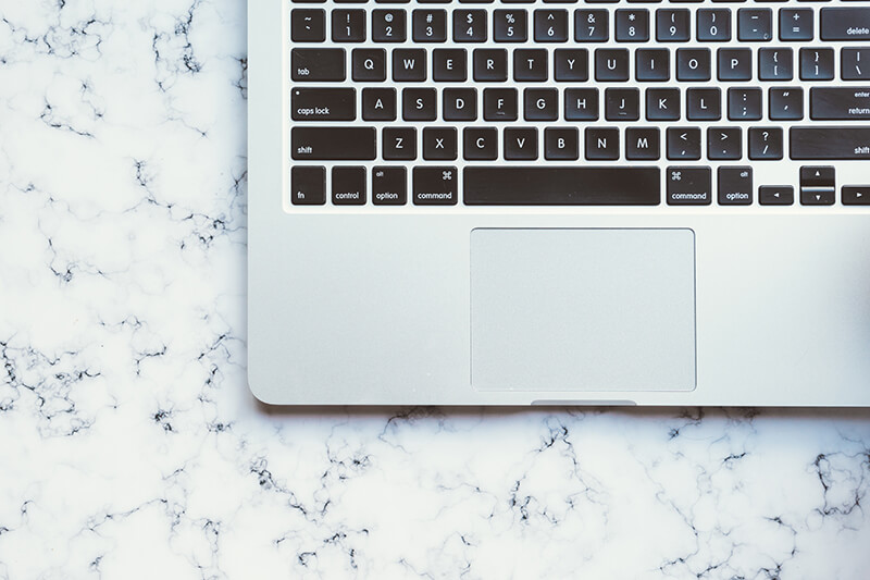 Laptop keyboard open to show the keys to press punctuation