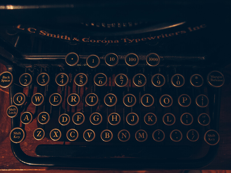 Closeup shot of a typewriter keyboard with punctuation marks on it