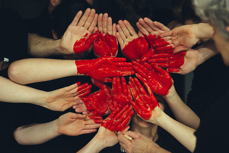 Happiness shown in friends with painted hearts on their hands