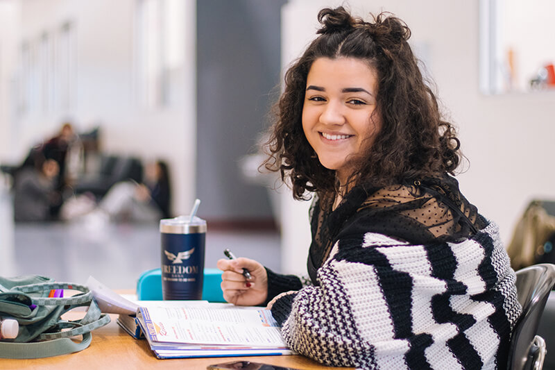 Happy female student learning format for APA style papers