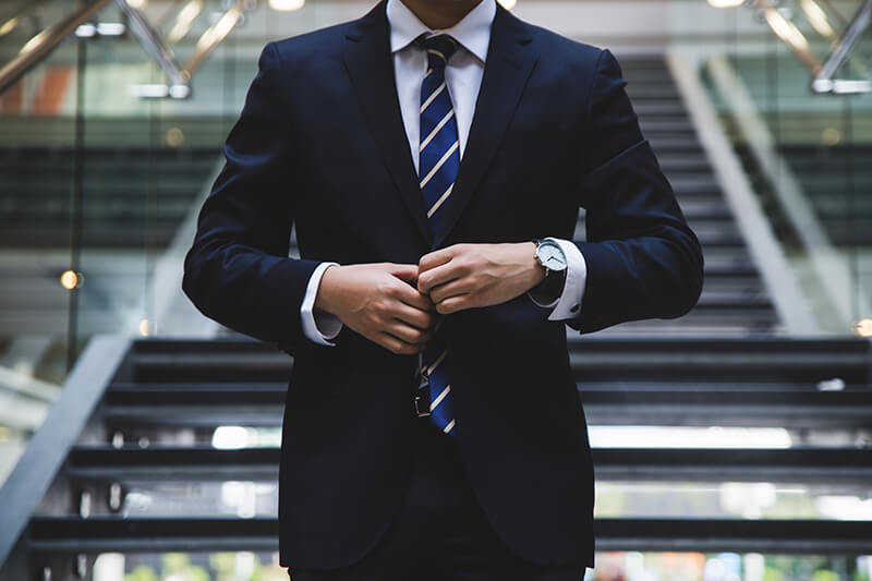 Male graduate wearing a suit walking into his job interview