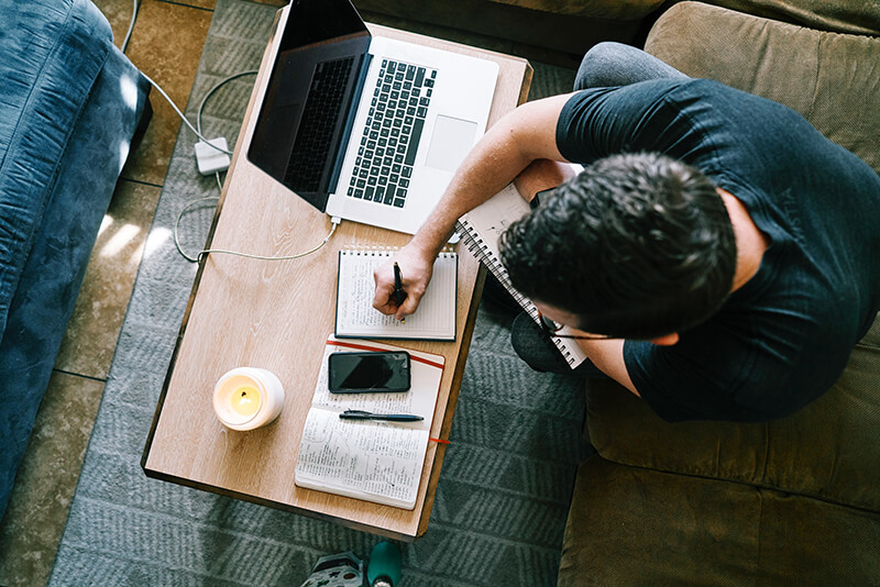 Male student sitting in a coffee shop going over his notes