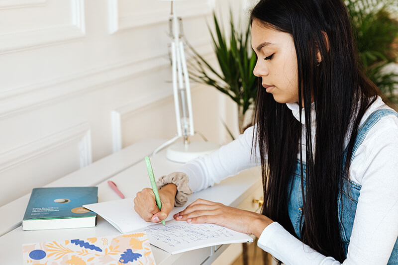 expository essay help Student brainstorming notes by hand to start the writing process