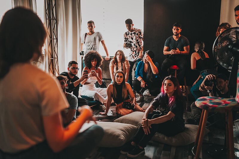 Woman presenting a speech to a casual audience in a coffeehouse