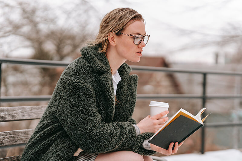 College student spending outdoor time reading and studying