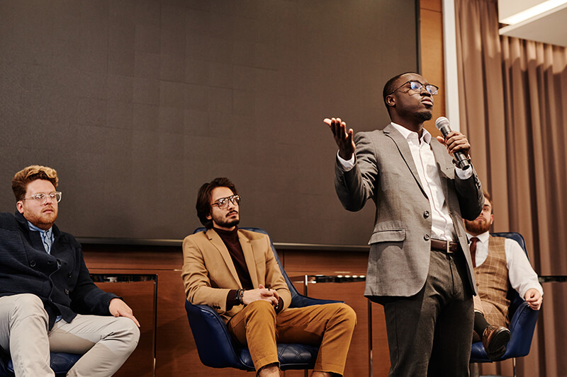 Male student in a class debate making a political speech