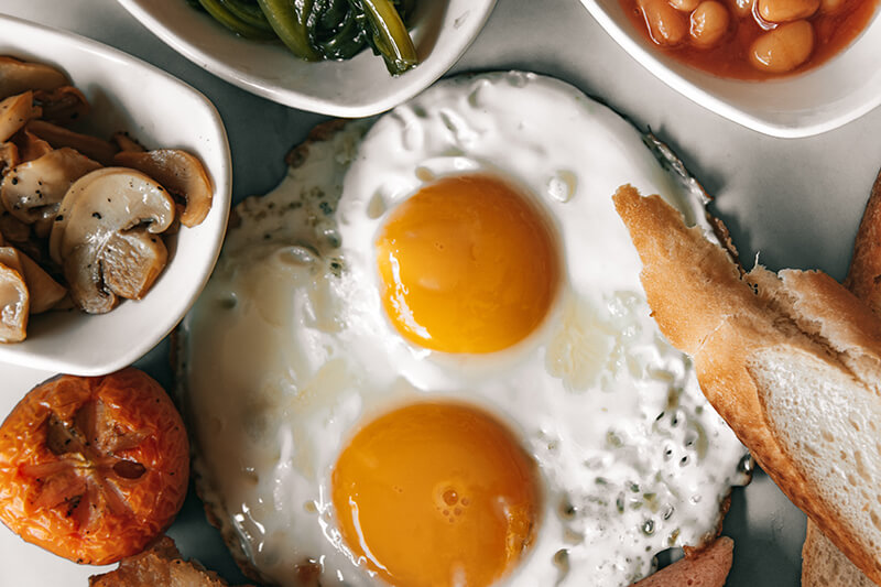 Plate with sunny side up eggs being eaten while studying