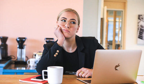 Female student thinking of how to write a history research paper