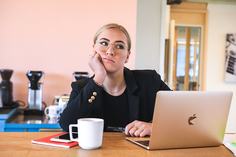 Female student thinking of how to write a history research paper