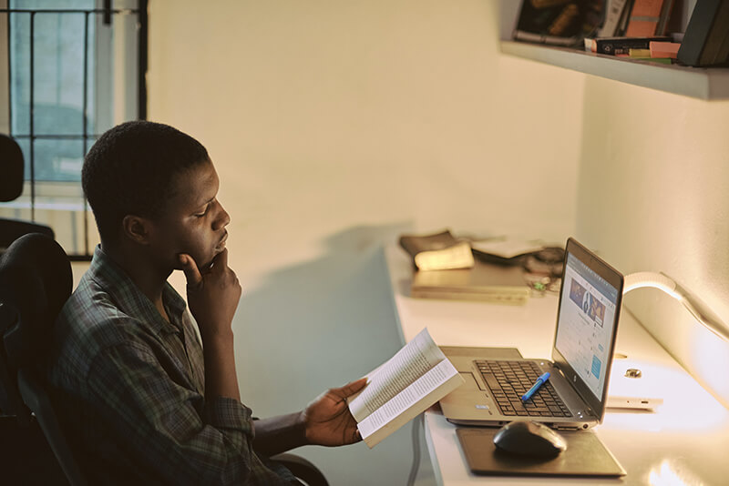 college student wondering about his homework as he studies