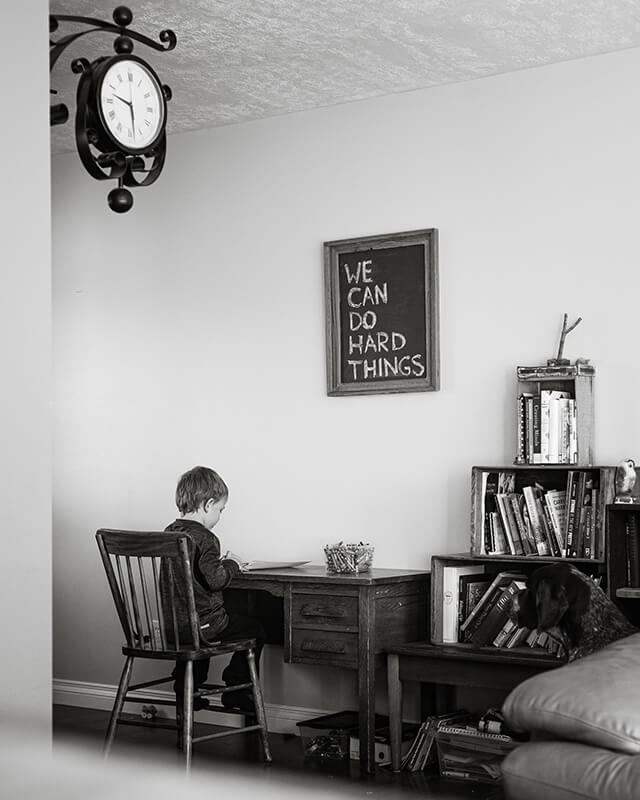 young student proving why homework is important as he independently does his assignment