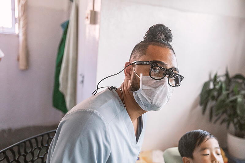 Levi Powell does dental procedure on young patient