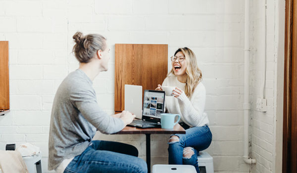 Two students discussing how to learn communication skills