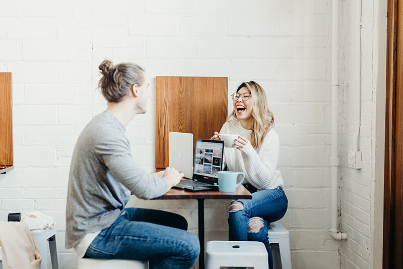 Two students discussing how to learn communication skills