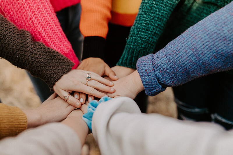 friends putting their hands together as a sign of teamwork