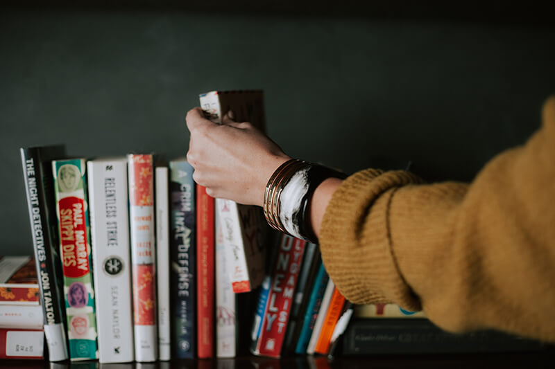 Student picks their favorite book from their collection